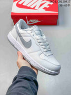 Close-up of a white low-top sneaker with gray Swoosh and outsole details