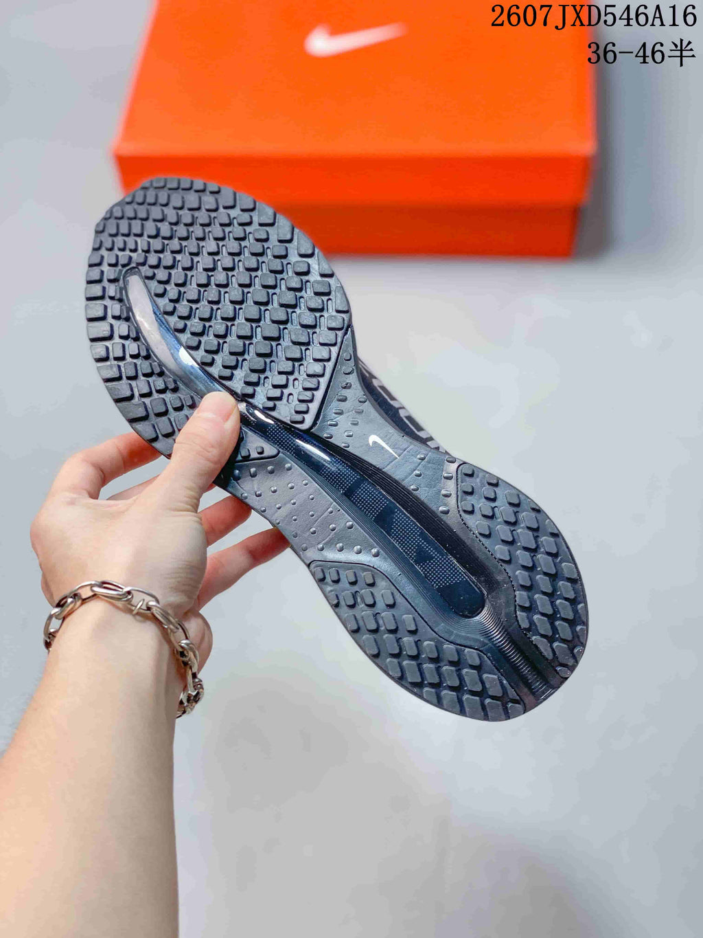 Underside view showing the sneakers’ segmented black traction outsole.