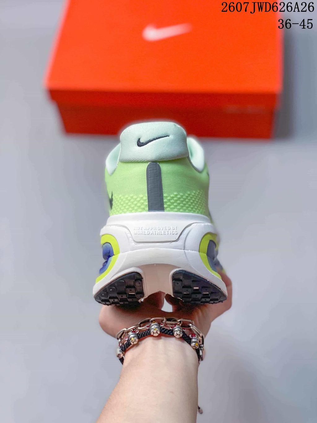 Rear view of the green sneaker pair showing the padded collars, heel details, and split outsole design.