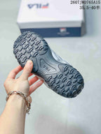 Close view of the black outsole showing its raised repeating tread pattern.