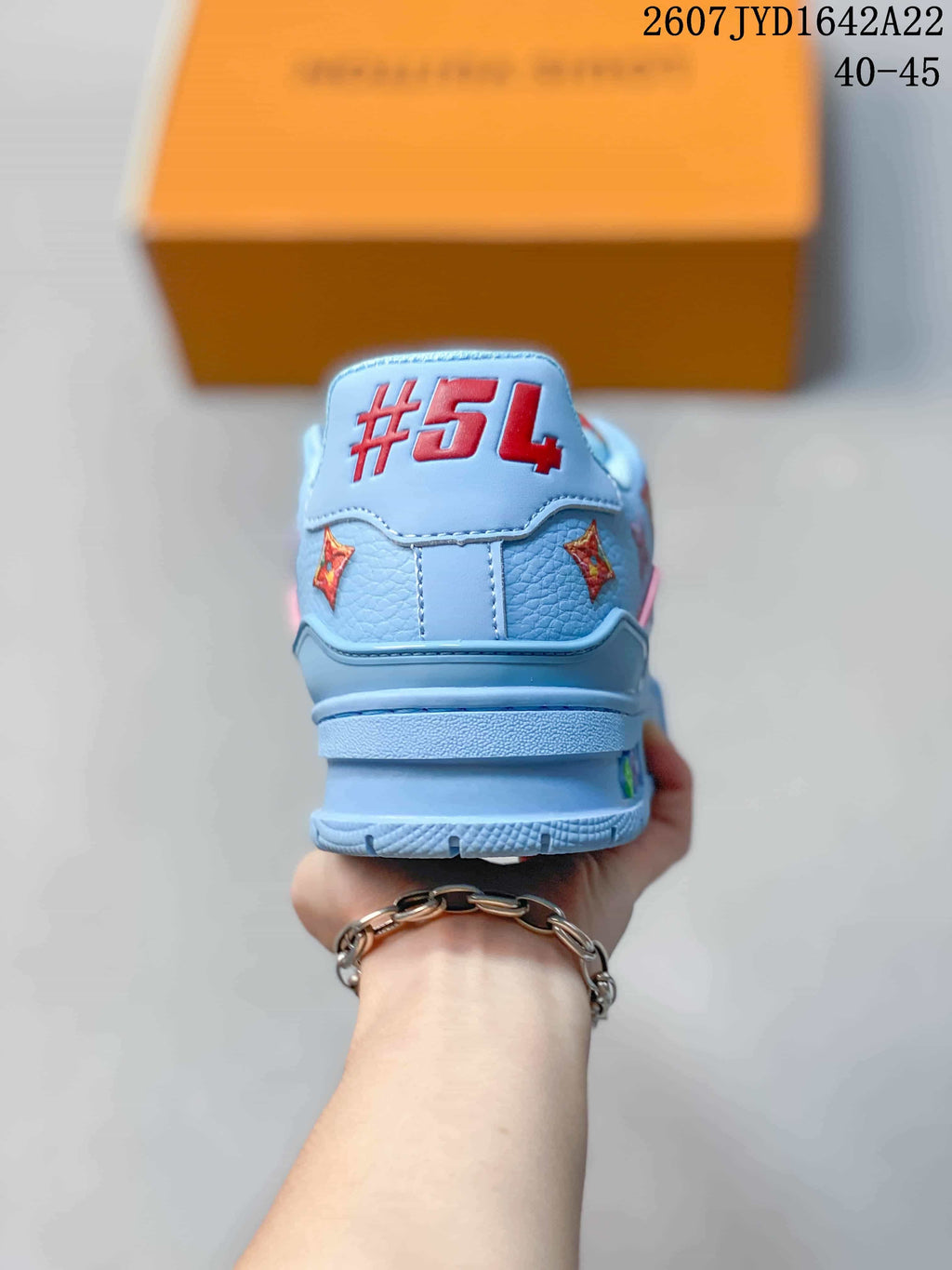 Rear view of the light blue sneaker showing the red #54 detail and patterned side accents.
