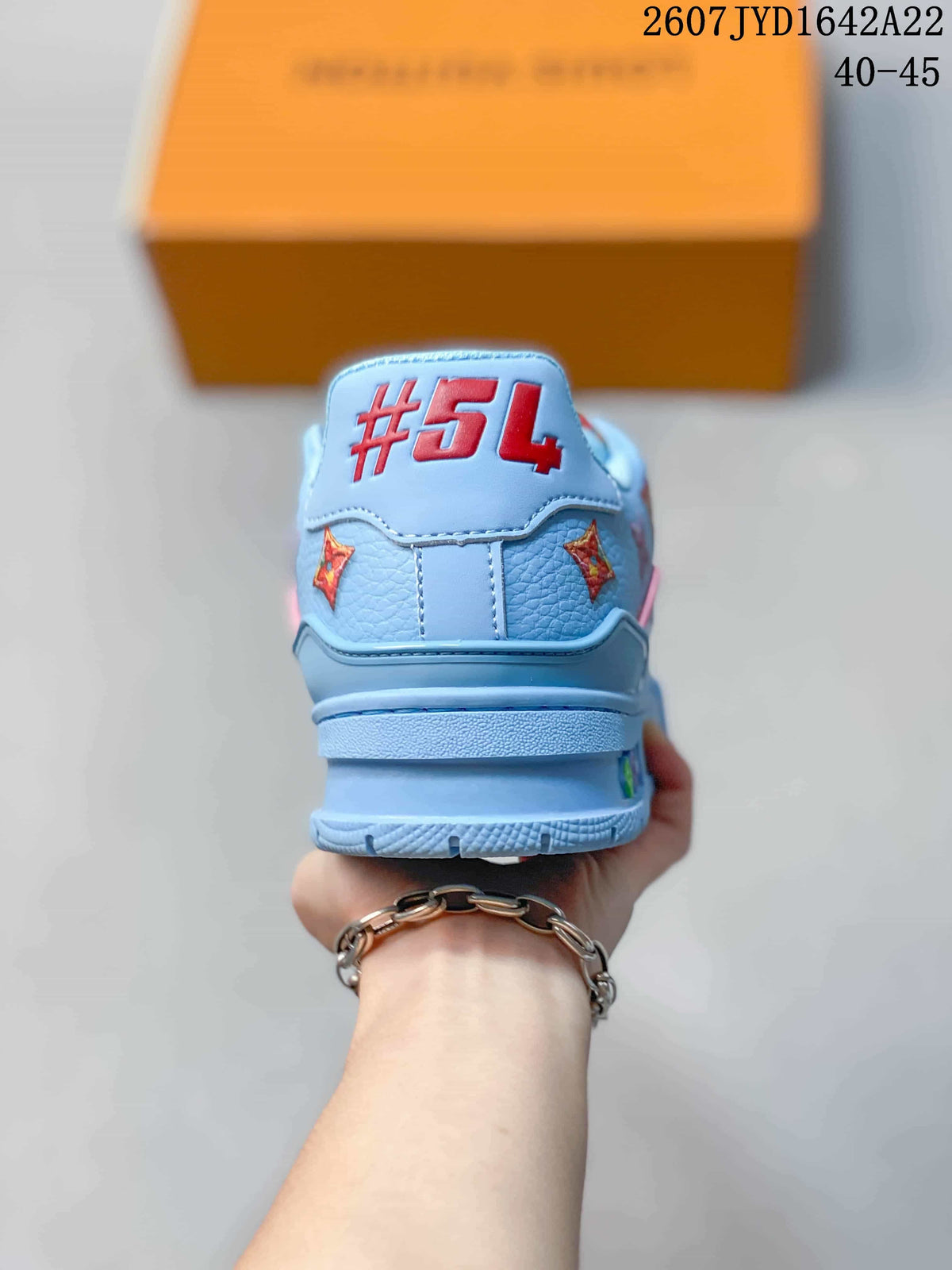 Rear view of the light blue sneaker showing the red #54 detail and patterned side accents.