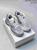 Pair of Saucony Pro Grid Omni 9 sneakers in white, silver, gold and dark navy displayed on a Saucony shoebox.