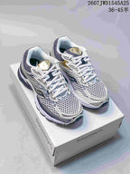 Pair of Saucony Pro Grid Omni 9 sneakers in white, silver, gold and dark navy displayed on a Saucony shoebox.