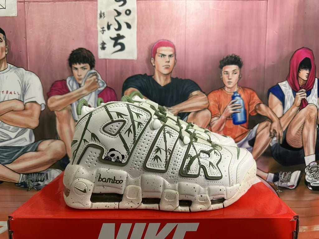 Side view of off-white Nike Air More Uptempo sneakers with dark green bamboo graphics and panda details.