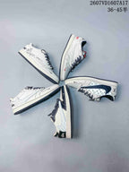 Several white low-top sneakers arranged in a circular layout, showing different graphic side-panel and color-detail variations.