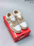Pair of white and tan Nike low-top sneakers displayed on a red shoebox.