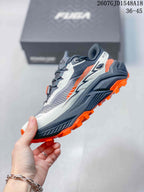 Side view highlighting the gray and white upper, layered midsole, orange outsole lugs, and FUGA heel branding.