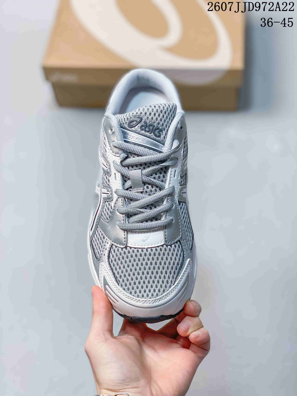 Front view showing the mesh-style toe box, gray laces, padded tongue and ASICS branding.