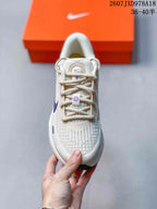 Top view showing the lacing system, breathable-looking mesh textile upper, and purple tongue details.