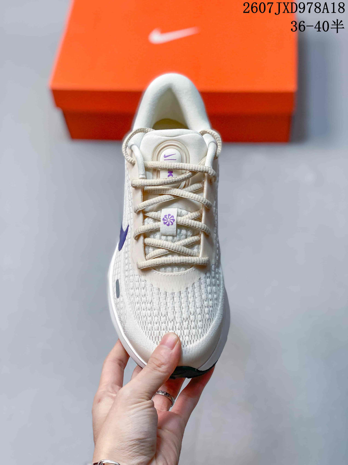 Top view showing the lacing system, breathable-looking mesh textile upper, and purple tongue details.