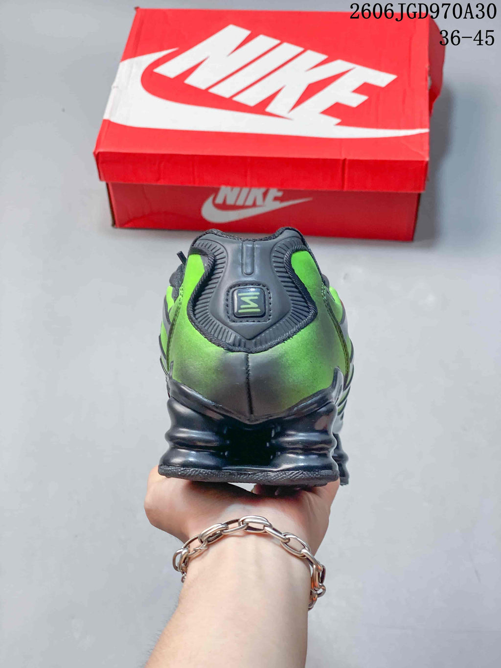 Rear view showing the green heel panels and sculpted sole