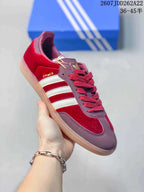 Angled side view showing the Samba side detail, white stripes, burgundy panels, and gum outsole.