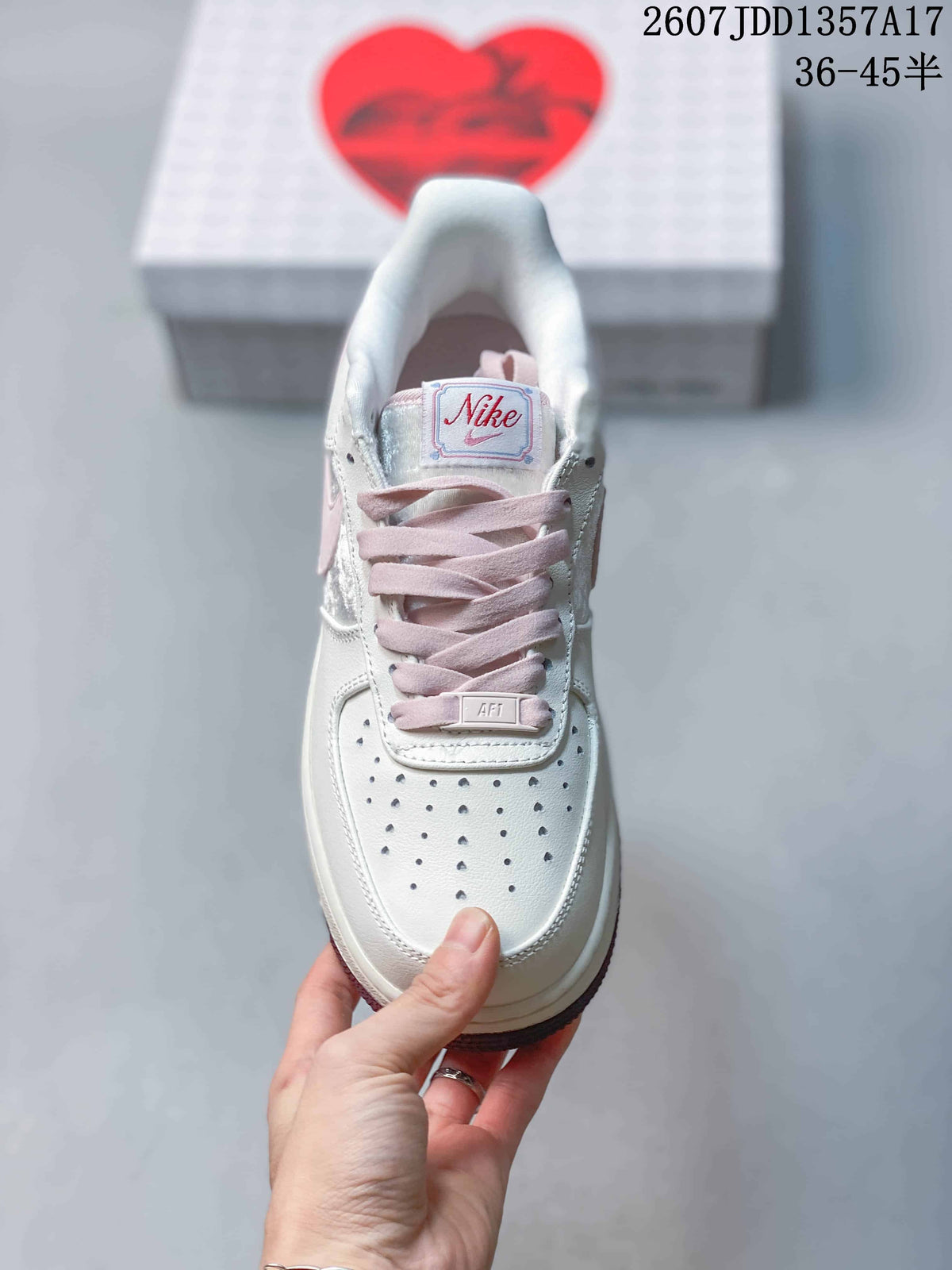Top view showing the perforated white toe box, pink laces and branded tongue label.