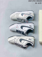 Three side-profile views of the off-white and black low-top sneakers showing the outsole, Swoosh details and shoe box.