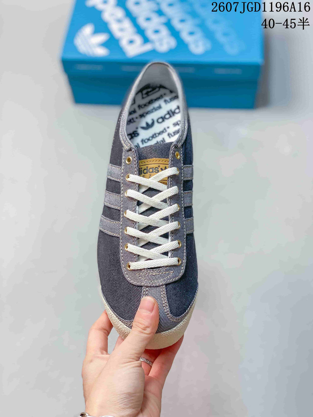 Top view showing the white laces, metal eyelets, tongue branding, and denim-look panels.