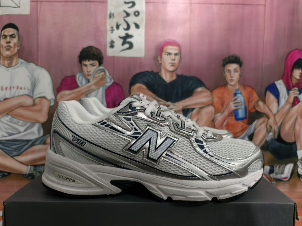 Side profile of a silver-tone New Balance 530 sneaker with mesh panels and a layered sole.