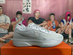 Side view of a white Nike basketball shoe with a visible swoosh and Zoom lettering at the forefoot