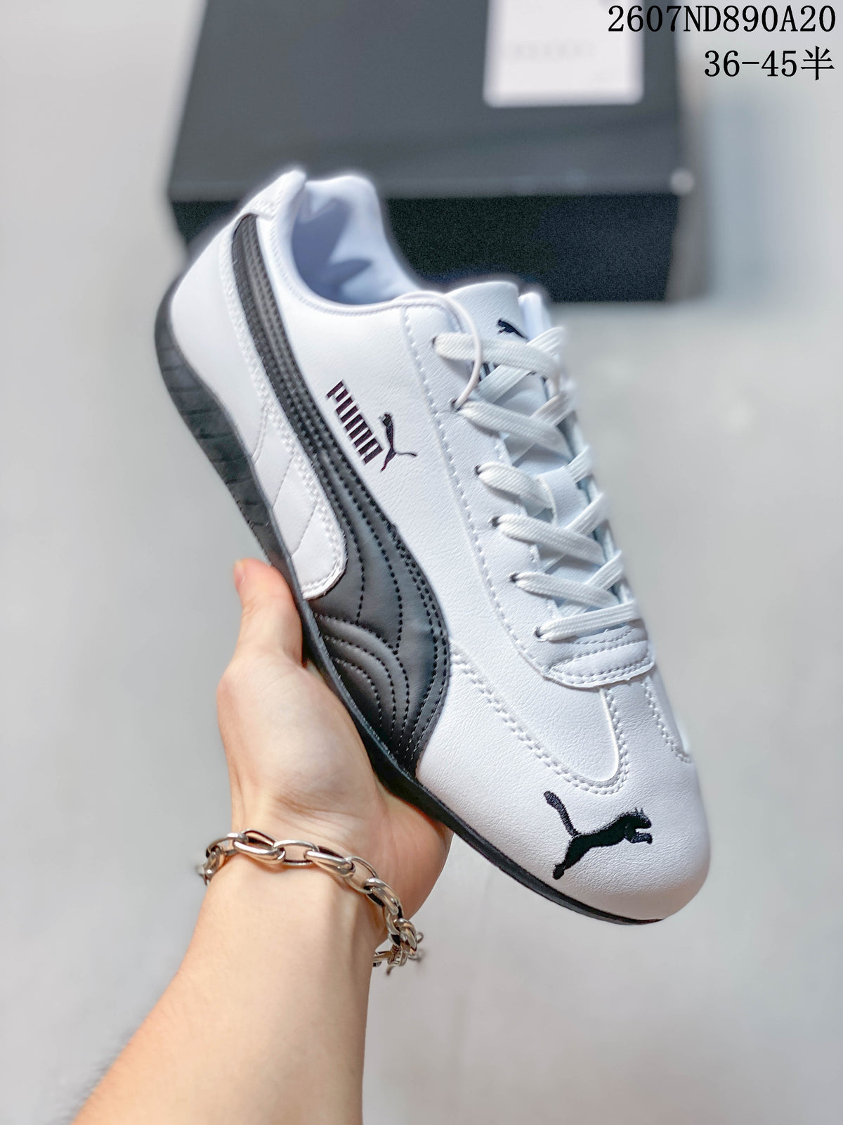 Angled side view of the white and black Puma sneaker with lace-up closure