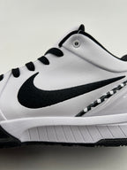 Side close-up of the black Swoosh, checkerboard trim, and white midsole