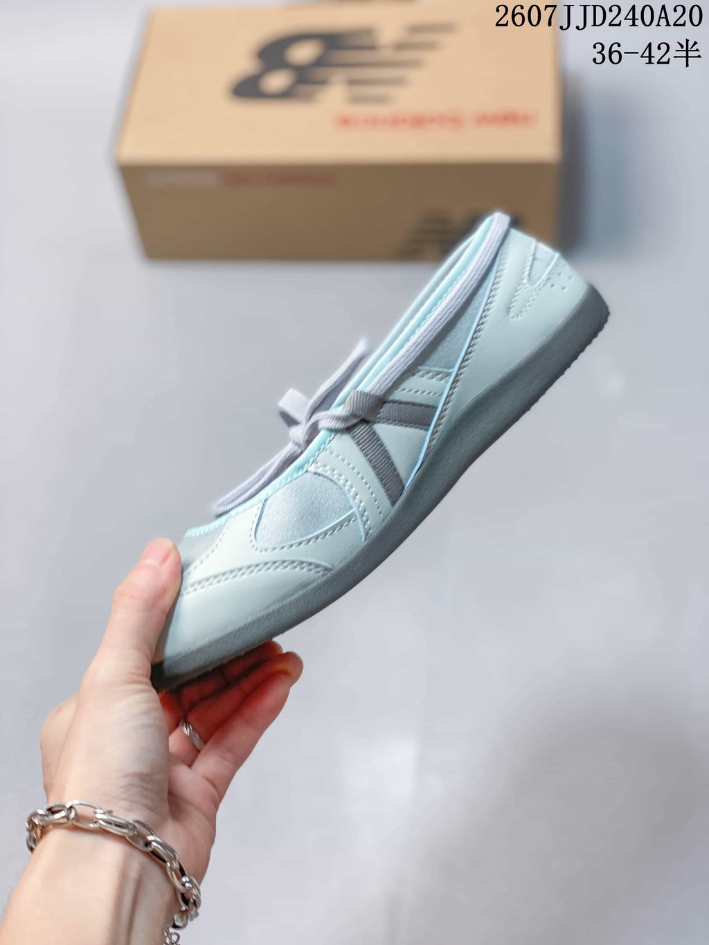 Side view showing the layered upper panels, lace-up closure, and low-profile sole.