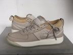 Pair of Nike Book 1 Ashen Slate shoes shown from the side in gray-beige and cream.