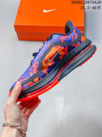 Side view of the patterned Nike running shoe with a dark midsole and visible cushioning element