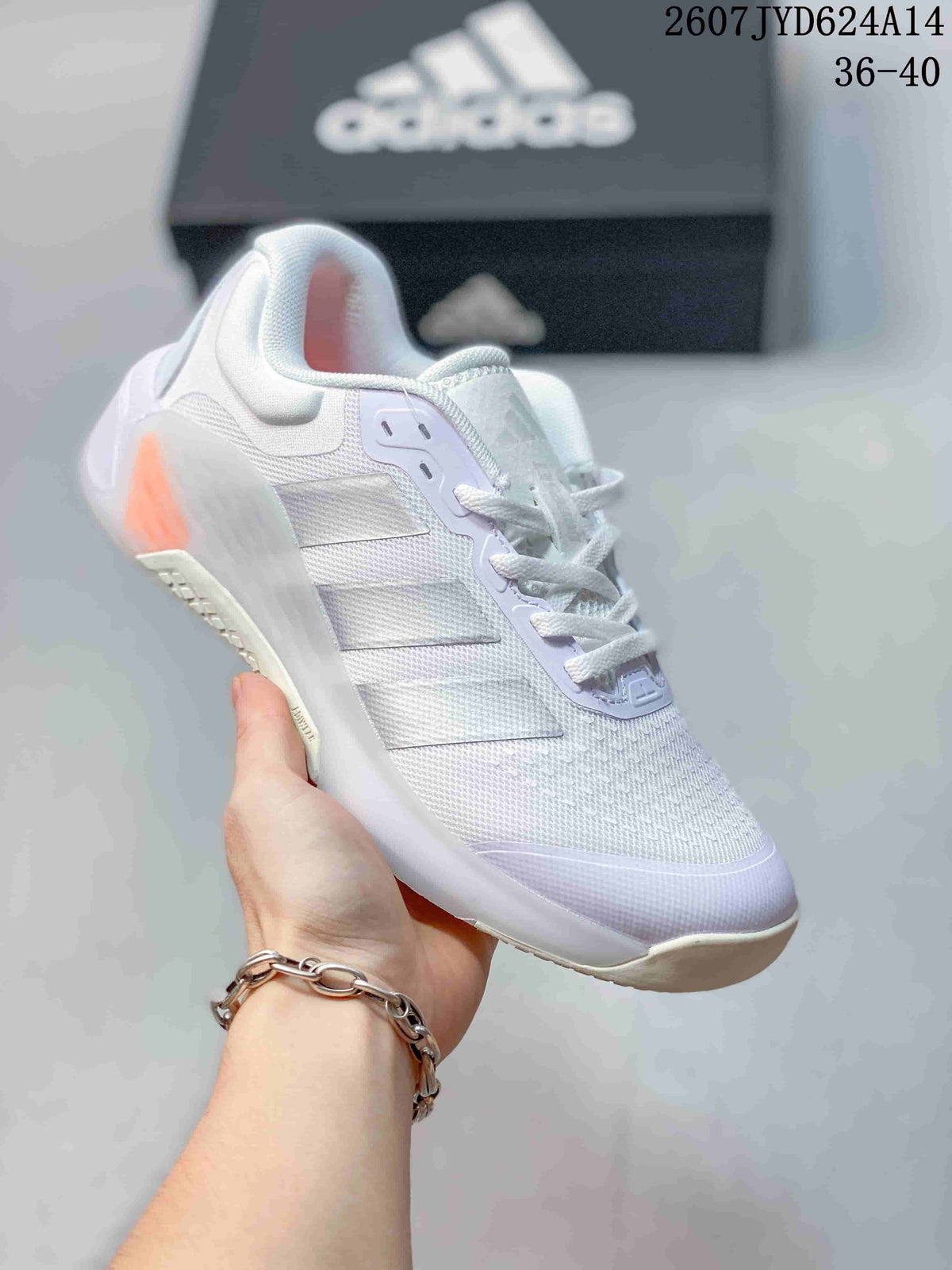 Angled side view of the white adidas Dropset 4 training shoe showing the mesh-textured upper, lace closure, side stripes, and orange heel accent.
