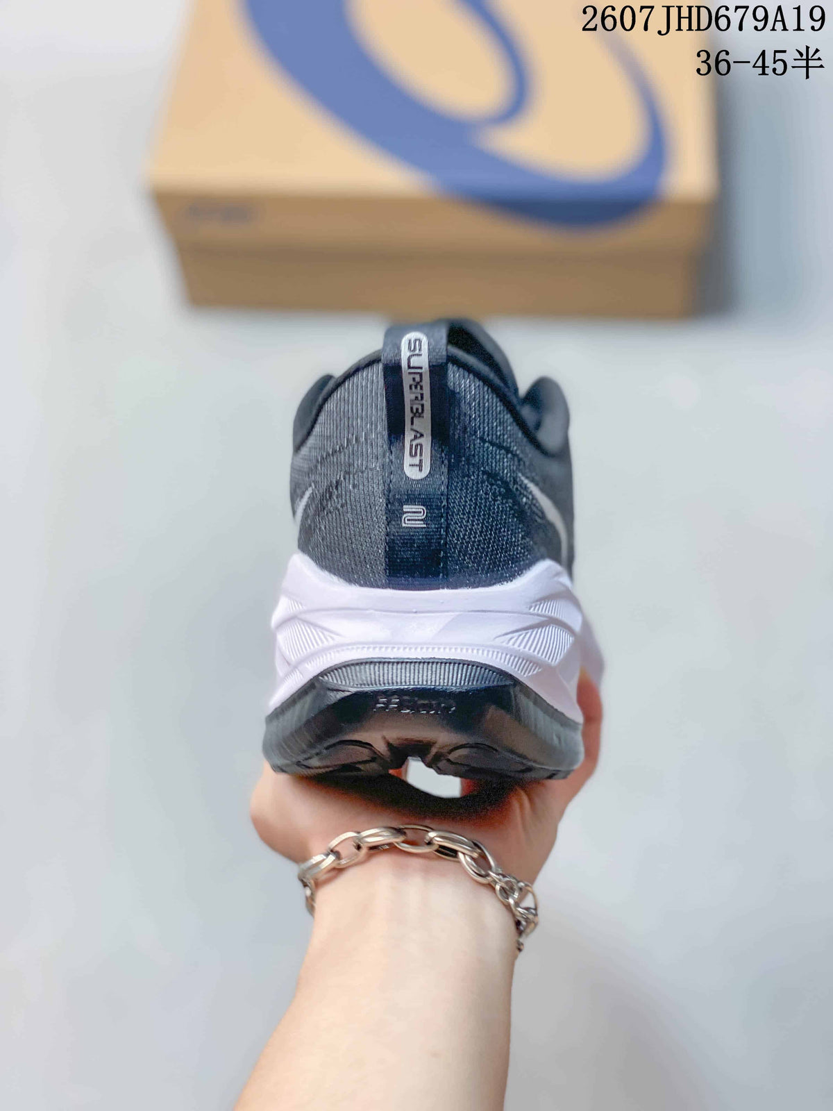 Rear view of the dark low-top sneaker showing the padded heel collar, pull tab and white midsole.