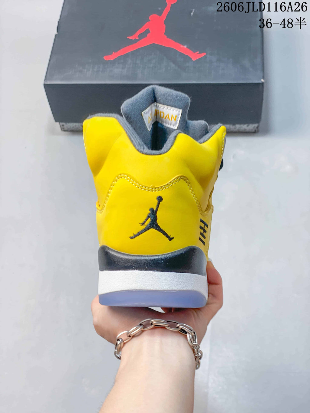 Rear view showing the yellow heel, Jumpman logo, and layered sole