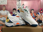 Angled view of Mizuno Wave Momentum 3 shoes showing white uppers, orange and green details, and multicolor heel panels.