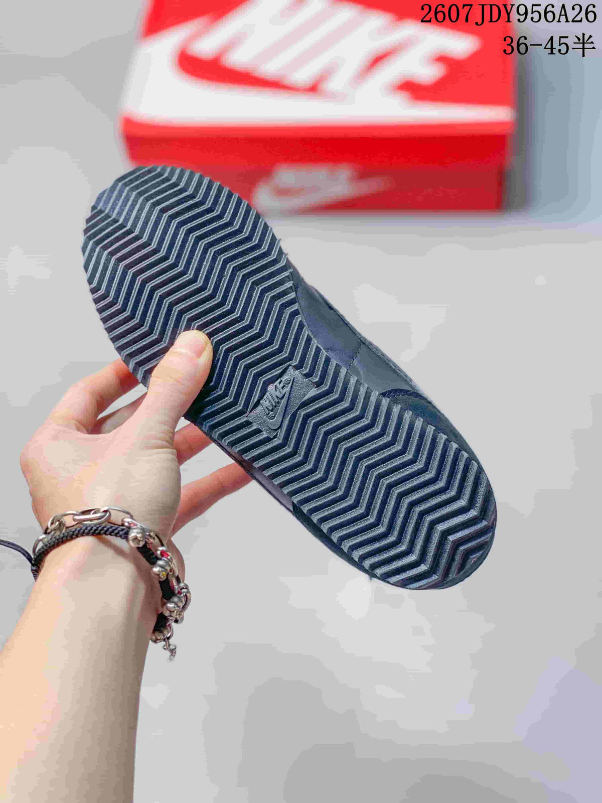 Close view of the black patterned rubber outsole with zigzag tread and a Nike detail.
