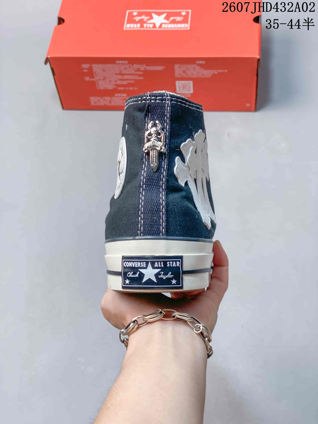 Rear view showing the heel label and decorative metal-tone detail