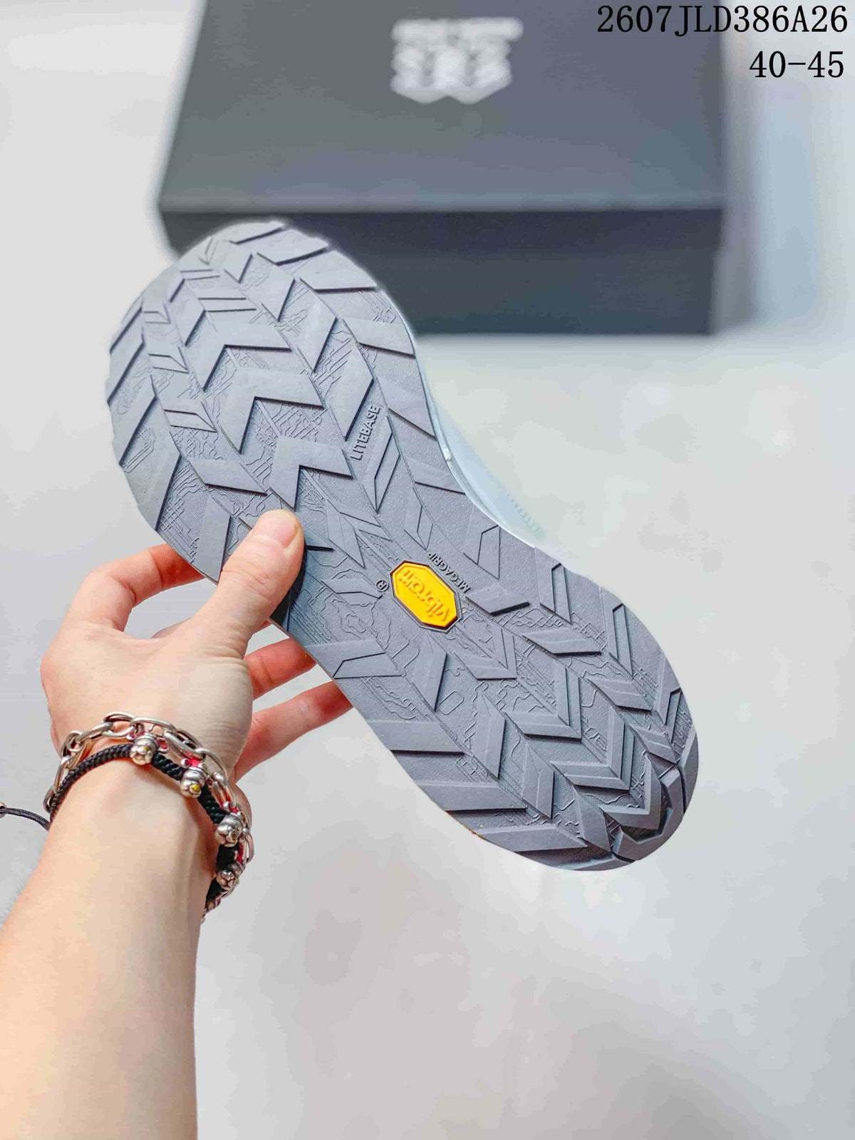 Close view of the sneaker outsole showing a deep directional tread pattern and a visible Vibram mark.