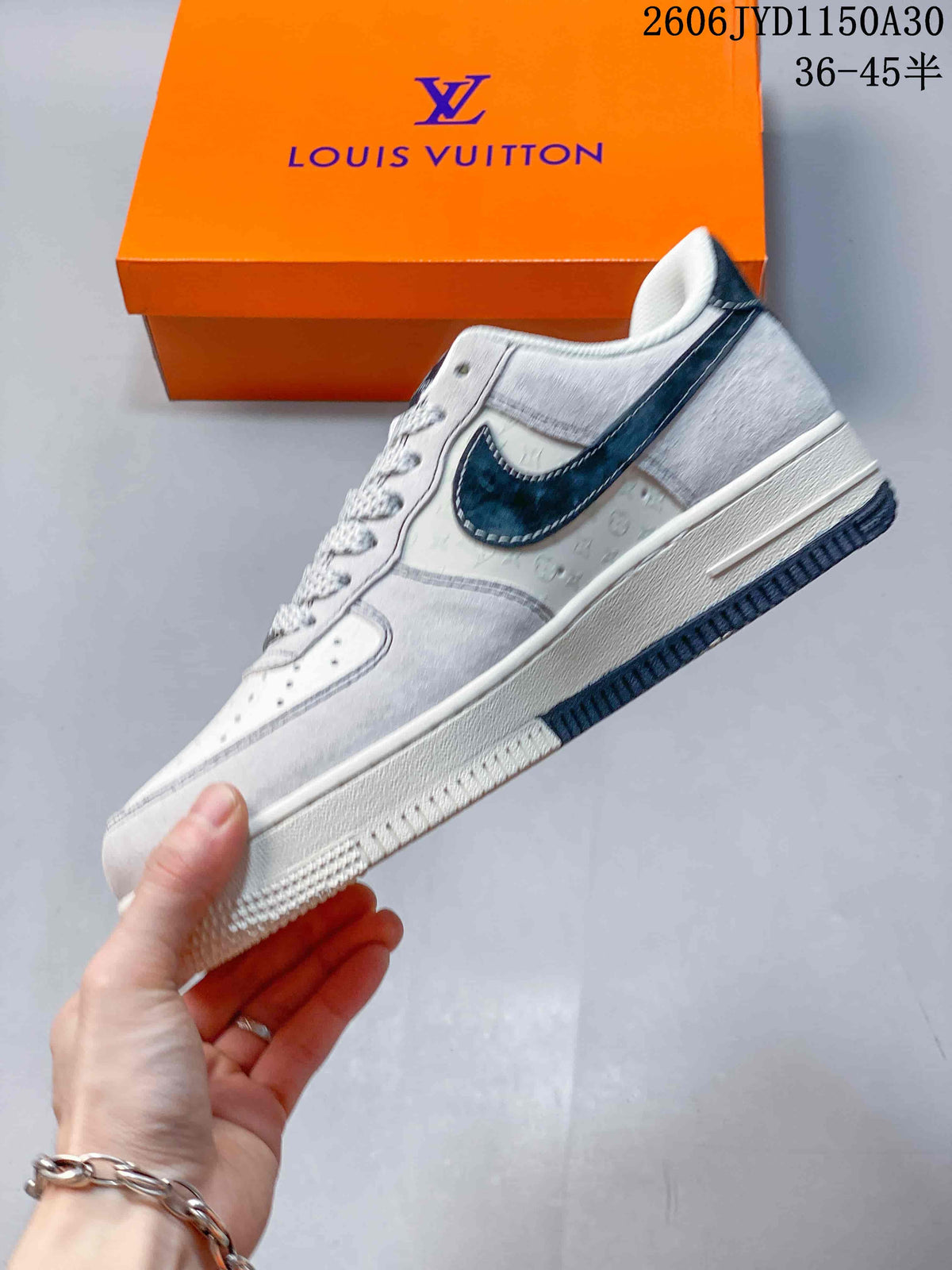 Side profile of a light-colored low-top sneaker with a dark side accent