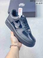 Angled side view of a black Nike Air Force 1 sneaker showing the Swoosh, Air sole marking and textured outsole.