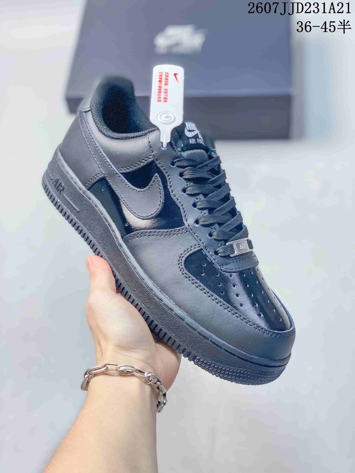 Angled side view of a black Nike Air Force 1 sneaker showing the Swoosh, Air sole marking and textured outsole.