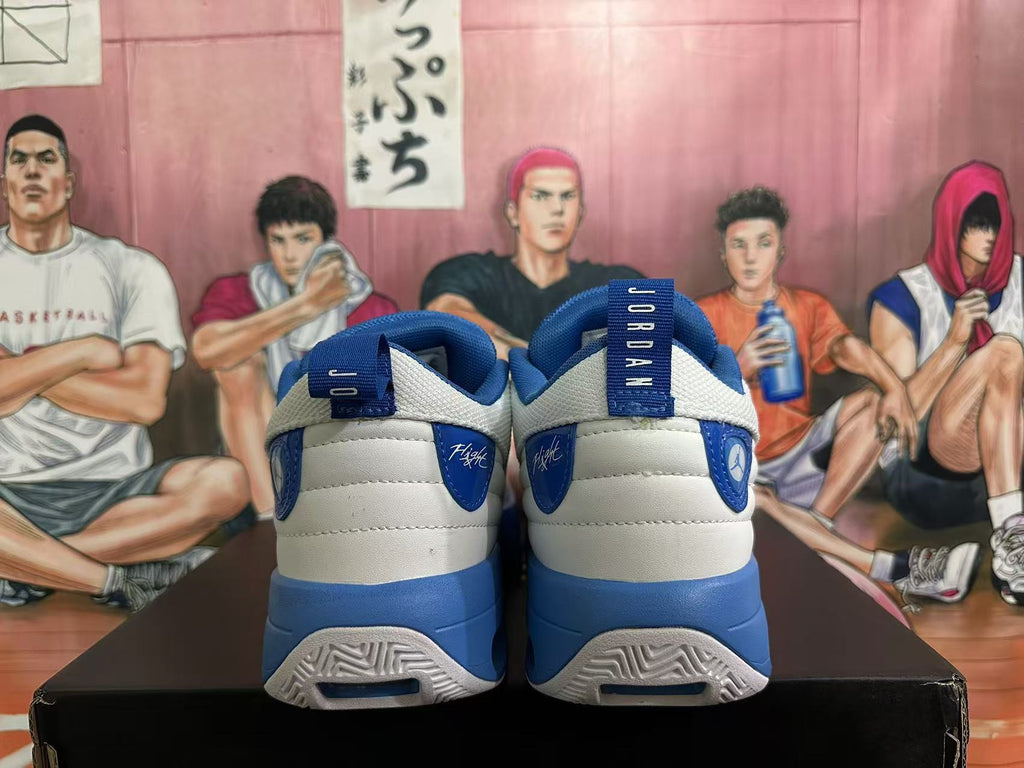 Rear view of white and blue Jordan sneakers showing heel branding, blue midsoles, and heel cushioning windows.
