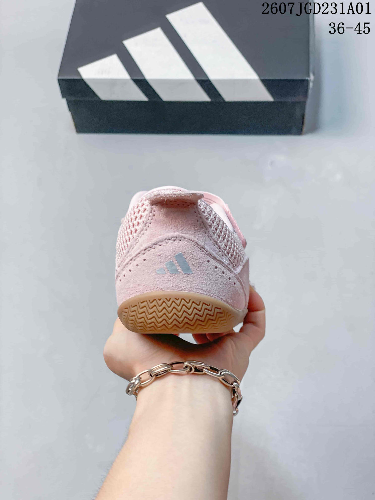 Rear view of a pink Adidas sneaker with a small logo and gum-colored outsole