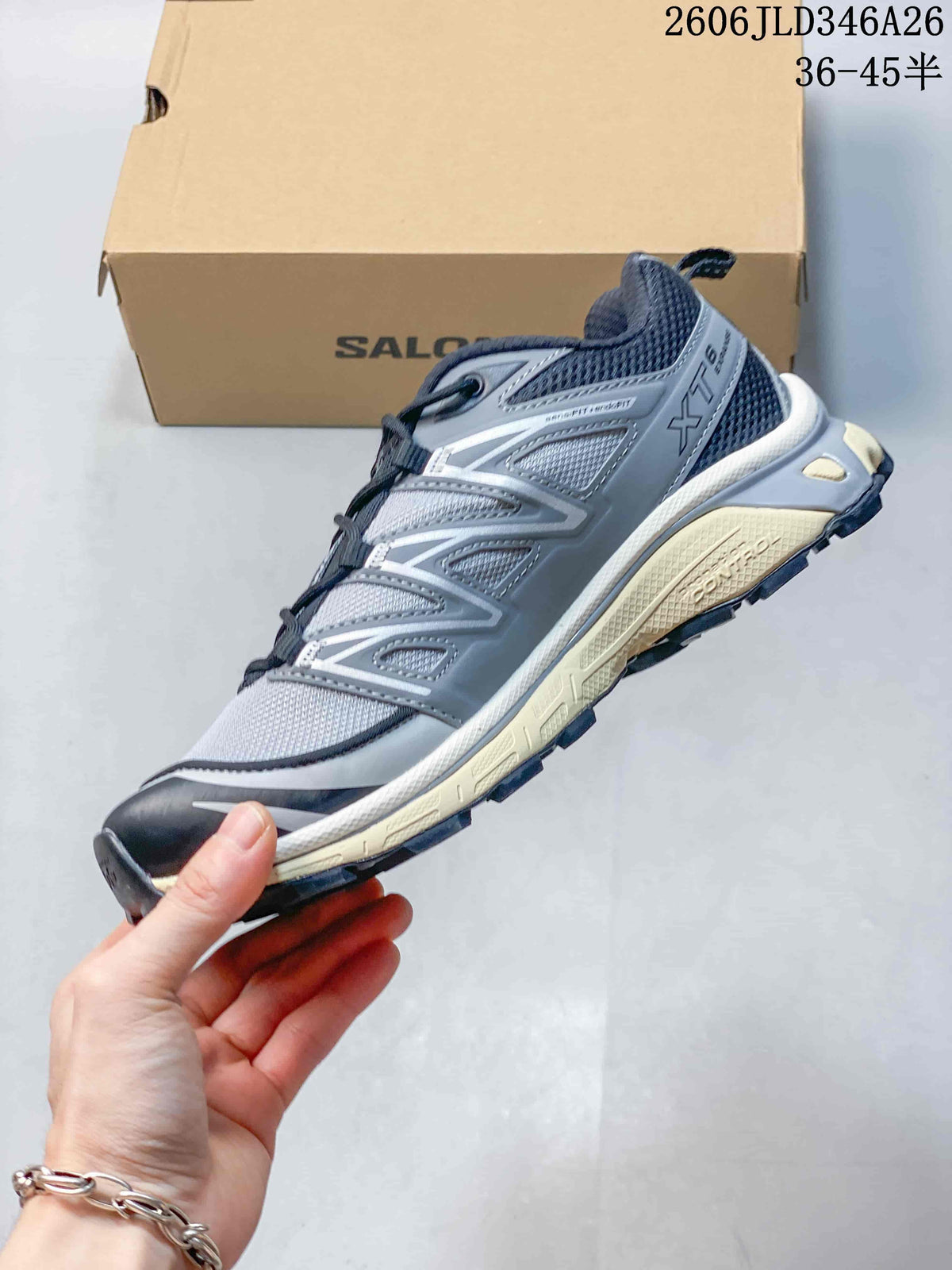 Side view of a gray Salomon XT-6 sneaker with dark accents and a lugged sole