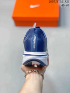 Rear view of the navy sneaker showing the padded heel, white midsole, and dark outsole details.