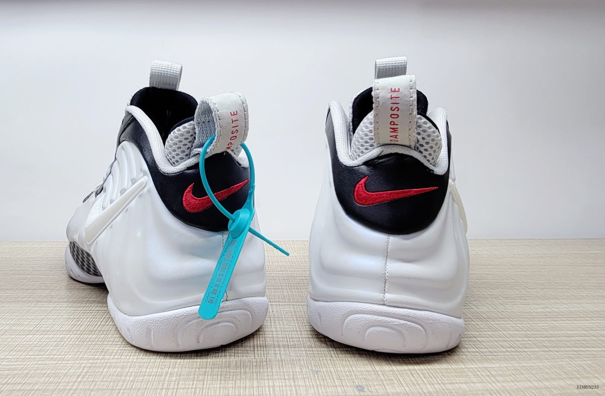 Rear view of cream-white Nike Air Foamposite Pro shoes with black heel panels and red accents