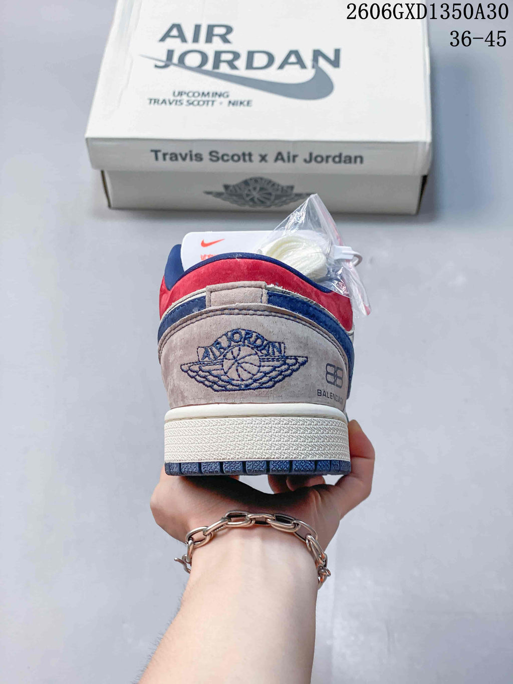 Rear view showing red and blue heel panels and embroidered graphics