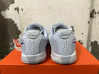 Rear view of light gray Nike Ja 1 basketball shoes with purple accents