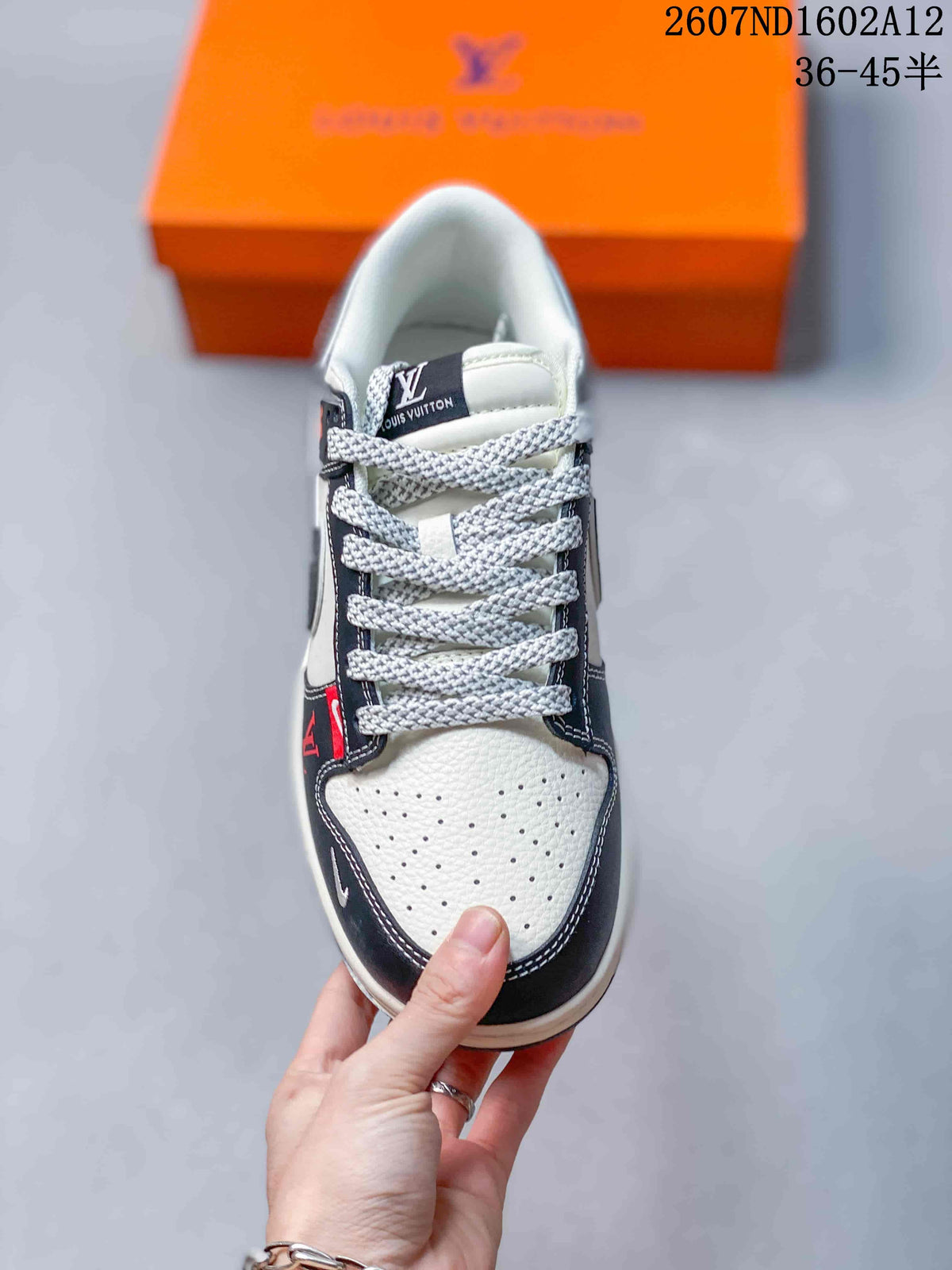 Top view of the sneaker showing light perforated toe panels, dark trim, patterned laces and a padded collar.