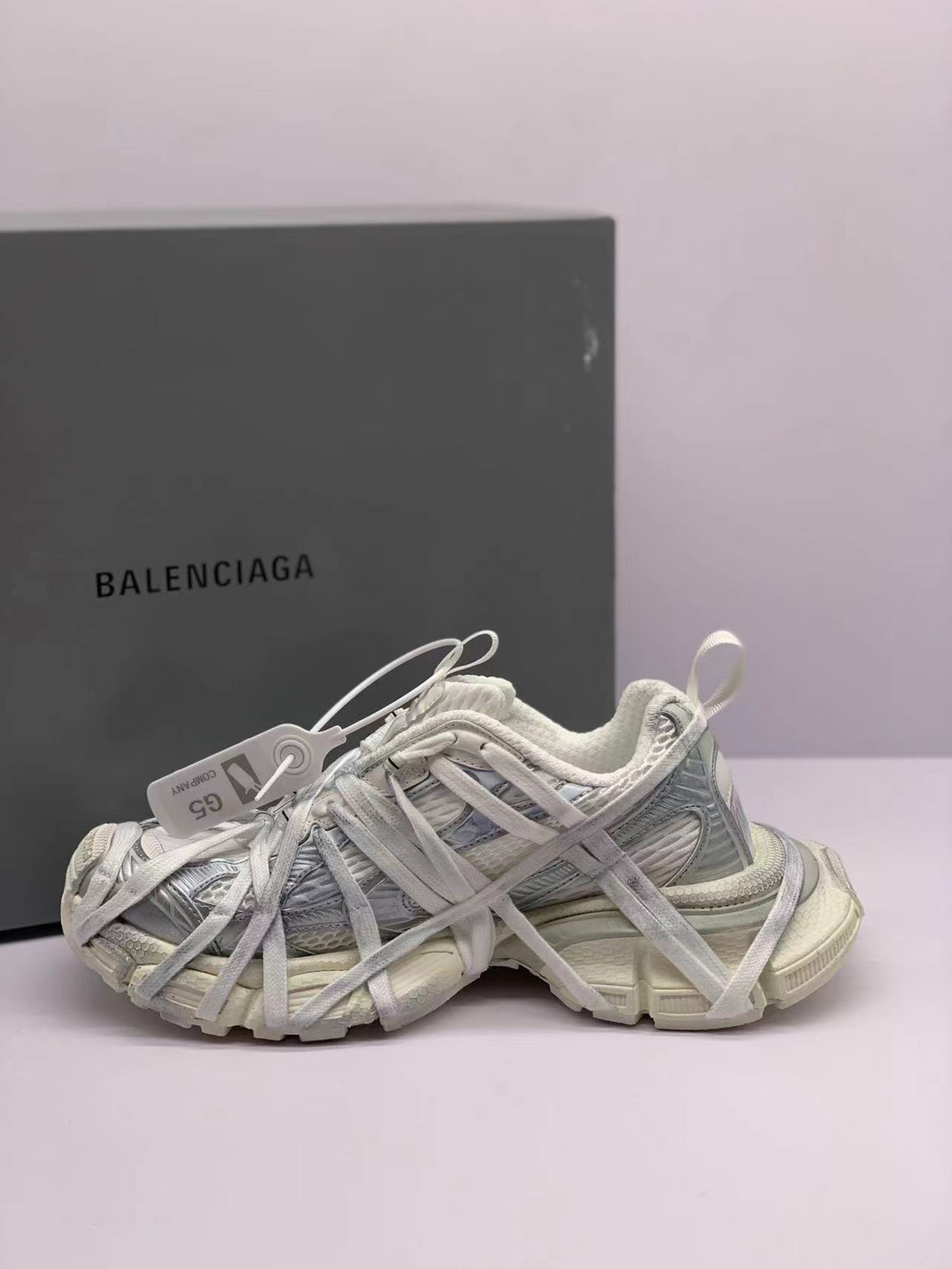 Opposite side view showing the layered lace construction, textured panels, and all-white colorway.