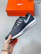 Side view showing the dark gray mesh-style upper, white Swoosh, and white midsole.