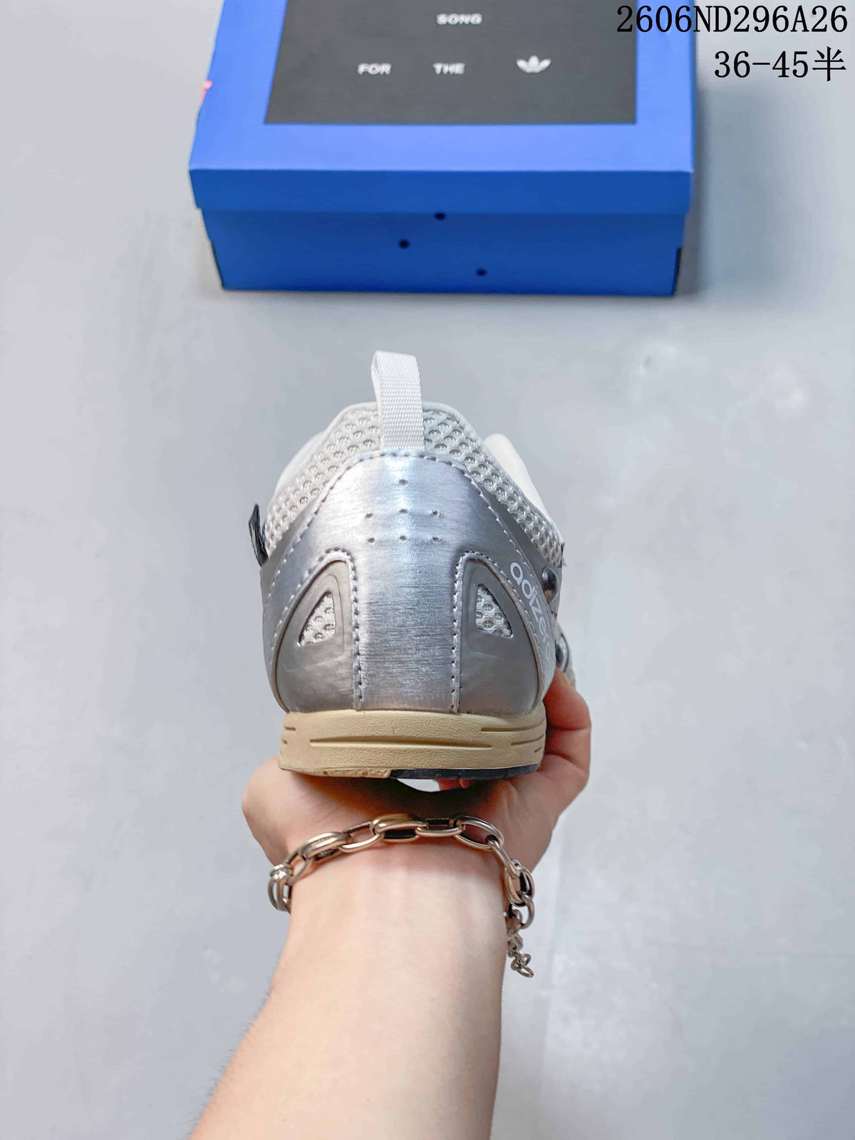 Rear view showing the padded heel collar, silver heel panel and gum-toned midsole.