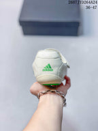 Rear view of the off-white shoe showing green adidas branding on the heel.