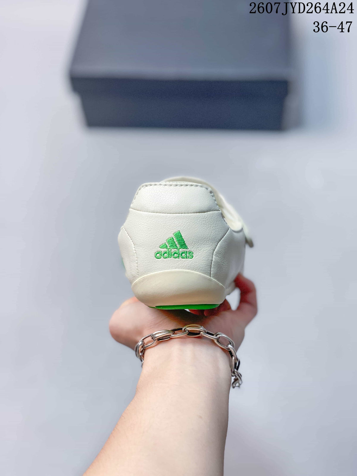 Rear view of the off-white shoe showing green adidas branding on the heel.